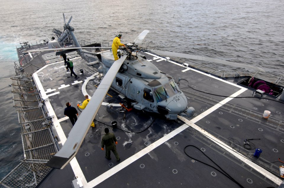 US Navy 110323-N-SF508-027 Sailors assigned to the Warlords of Helicopter Anti-Submarine Squadron Light (HSL) 51 decontaminate an SH-60B Sea Hawk h