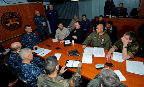 US Navy 110321-N-AQ172-009 Liaison officers from coalition countries meet with Joint Task Force Odyssey Dawn staff members aboard the amphibious co