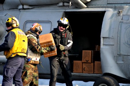 US Navy 110322-N-DM338-138 Sailors load boxes of Meals Ready-to-Eat onto an SH-60B Sea Hawk helicopter