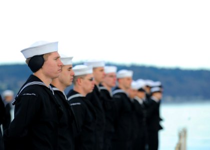US Navy 110324-N-JN612-077 Sailors tand at parade rest aboard USS Abraham Lincoln (CVN 72) as the ship pulls into its homeport of Everett, Wash photo