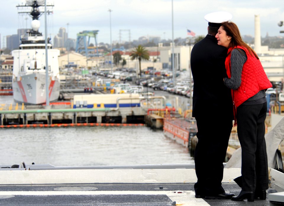 US Navy 110321-N-KB563-208 Cmdr. Michael Smith says goodbye to his wife aboard the amphibious transport dock ship USS Cleveland (LPD 7)