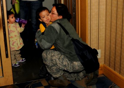 US Navy 110322-N-VA590-027 Senior Airman Melissa Campbell, assigned to American Forces Network Misawa, hugs her son as her family prepares for thei