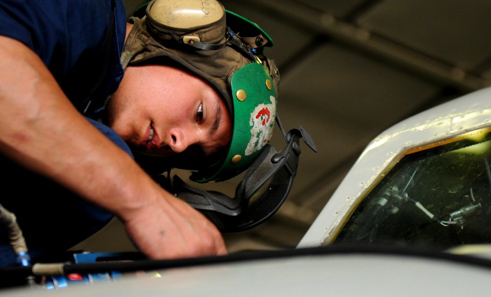US Navy 110325-N-6505H-031 Aviation Electrician's Mate Airman Brandon Walker, assigned to Carrier Airborne Early Warning Squadron (VAW) 125, perfor