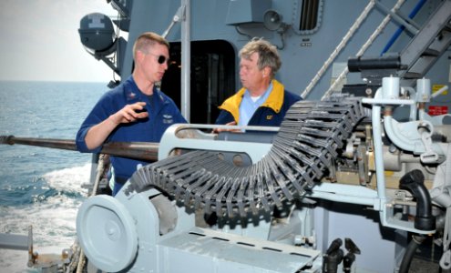 US Navy 110324-N-AW702-002 Gunner's Mate 2nd Class Ryan Ruch explains 25mm machine gun operation to Harvey Oltman