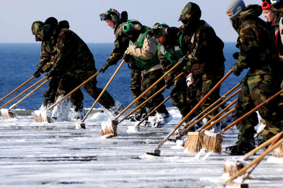 US Navy 110323-N-IC111-436 Sailors scrub the flight deck aboard the aircraft carrier USS Ronald Reagan (CVN 76) following a countermeasure wash dow