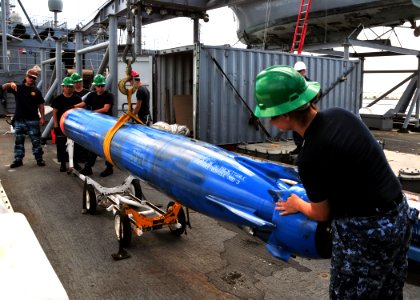 US Navy 110322-N-BK435-063 Sailors and civilian mariners assigned to the submarine tender USS Frank Cable (AS 40) lower a 3,000-pound