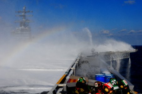 US Navy 110323-N-UO379-006 Sailors and Marines take cover from thousands of gallons of aqueous film forming foam solution during a countermeasure w