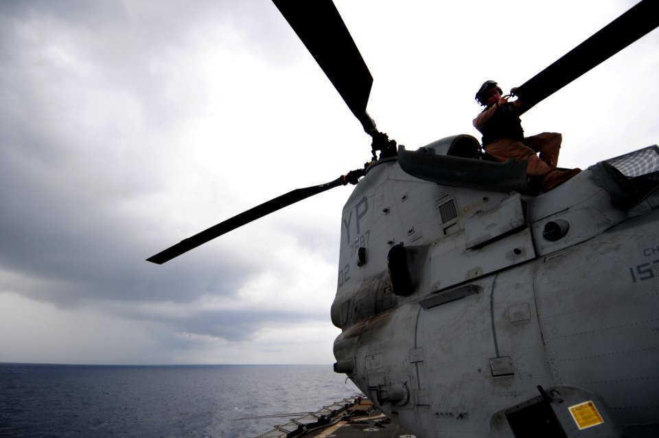 US Navy 110323-N-RC734-214 Lance Cpl. David Tinder, assigned to the Evil Eyes of Marine Medium Helicopter Squadron (HMM) 163, performs maintenance
