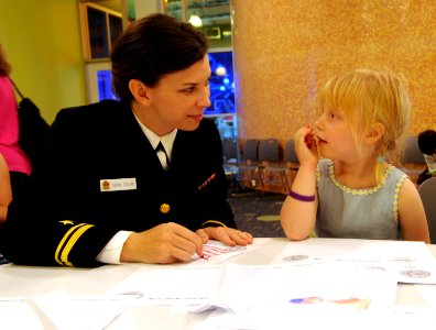 US Navy 110323-N-ZL585-079 Lt. j.g. Cheryl Collins, assigned to Navy Office of Community Outreach, colors with a young visitor