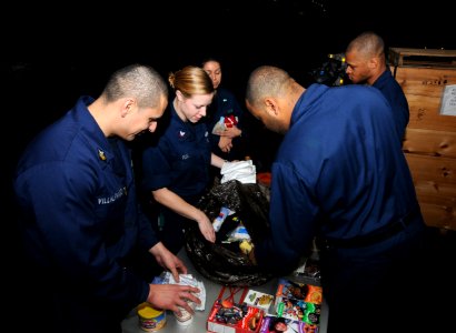 US Navy 110326-N-NB544-034 Sailors donate clothes, food and toiletries designated for Japanese disaster relief in the hangar bay aboard USS Ronald
