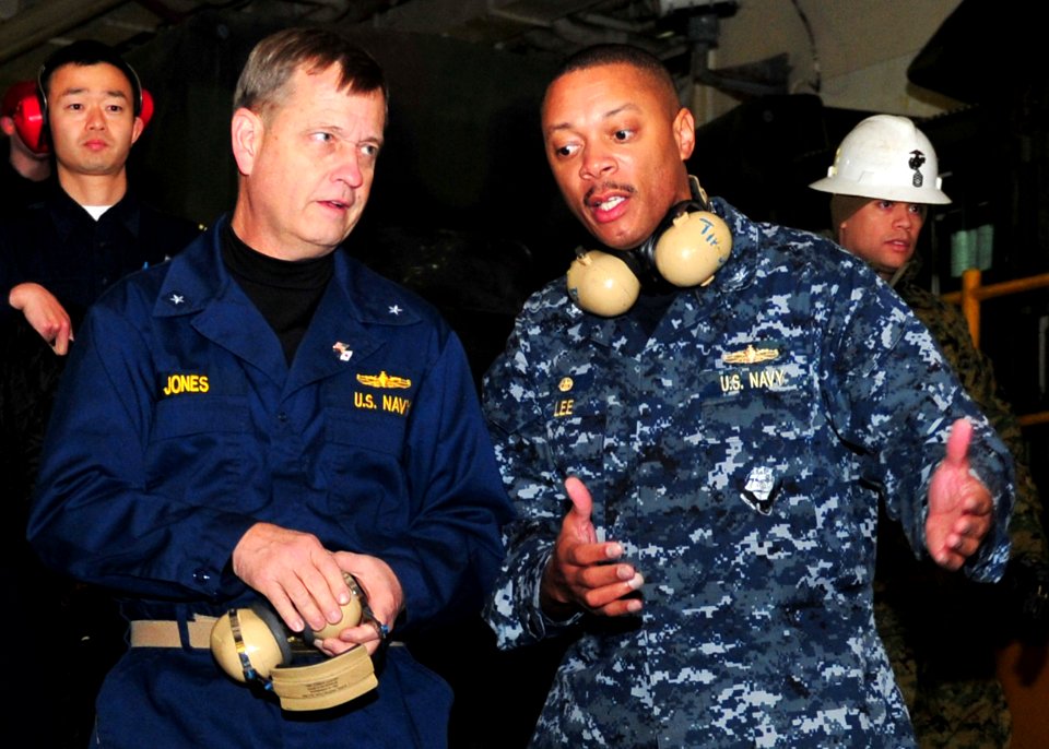 US Navy 110327-N-5538K-083 Rear Adm. Jeffery S. Jones, left, discusses humanitarian assistance operations with Capt. Bradley Lee, commander of Amph