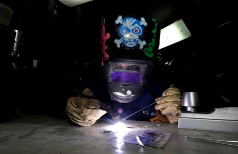 US Navy 110324-N-5031T-109 Hull Technician Fireman Eric Taylor, from Mansfield, Ohio, restores a door in the sheet metal shop photo