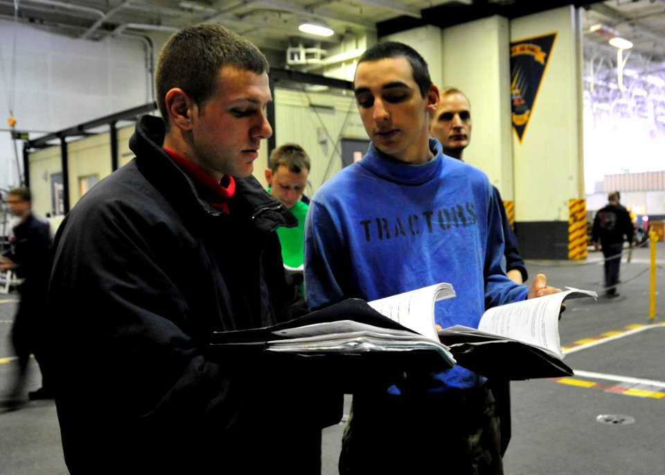 US Navy 110327-N-9626Y-021 Aviation Boatswain's Mate (Handling) Brandon Thur and Aviation Boatswain's Mate (Handling) Nicholas Imperatore look thro