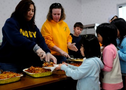 US Navy 110327-N-MU720-031 Volunteers erve food to children at the Biko-en Children's Care House