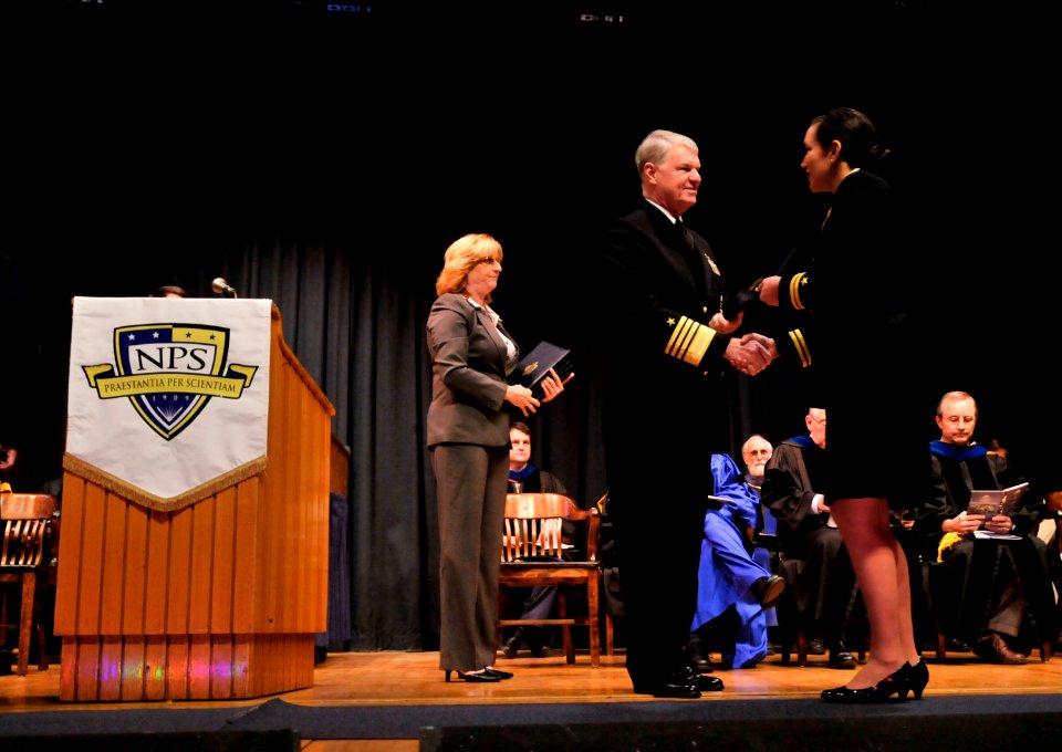 US Navy 110325-N-ZB612-174 Chief of Naval Operations (CNO) Adm. Gary Roughead presents diplomas to students during a graduation ceremony at the Nav