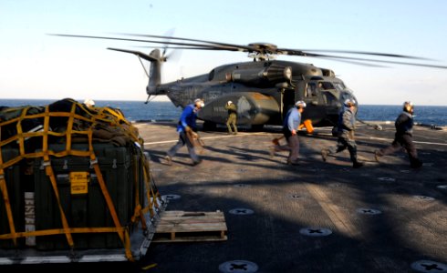 US Navy 110328-N-5716H-230 Sailors run across the flight deck aboard the amphibious transport dock ship USS Tortuga (LSD 46) photo