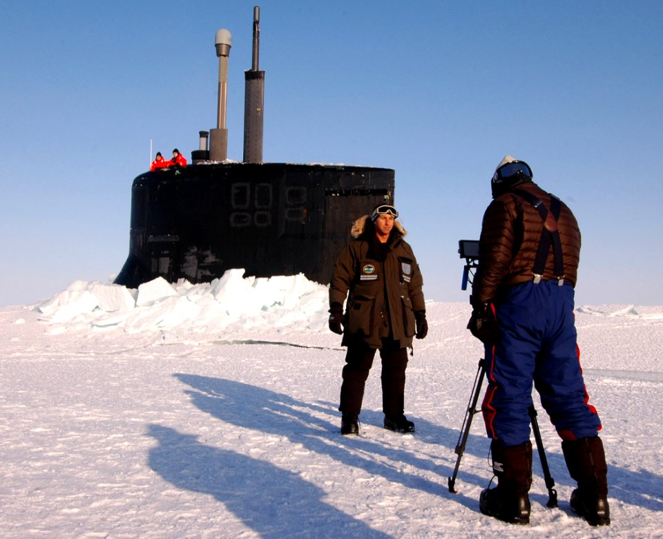 US Navy 110326-N-7058E-050 NN correspondent Kaj Larsen films a documentary segment in front of the sail of USS Connecticut (SSN 22) during Ice Exer