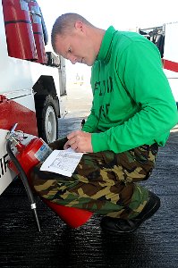 US Navy 110328-N-2908M-004 Aviation Support Equipment Technician Airman Roy Young checks halon bottles aboard USS Kearsarge (LHD 3)