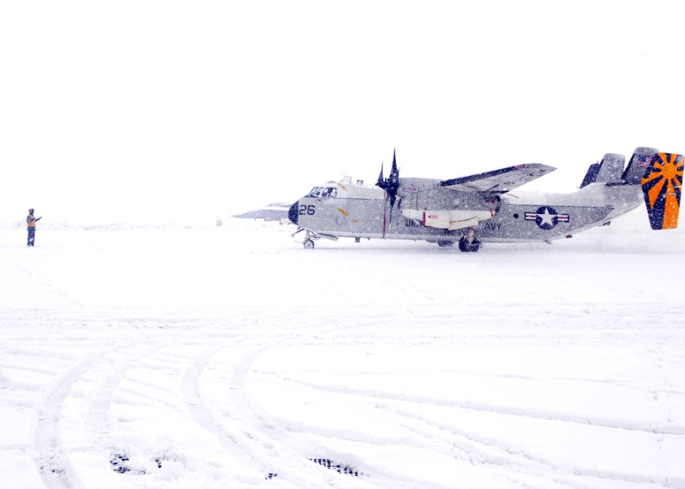 US Navy 110326-N-MU720-030 Flight directors from Naval Air Facility Misawa guide a C-2 passenger plane onto the Navy ramp to disembark personnel