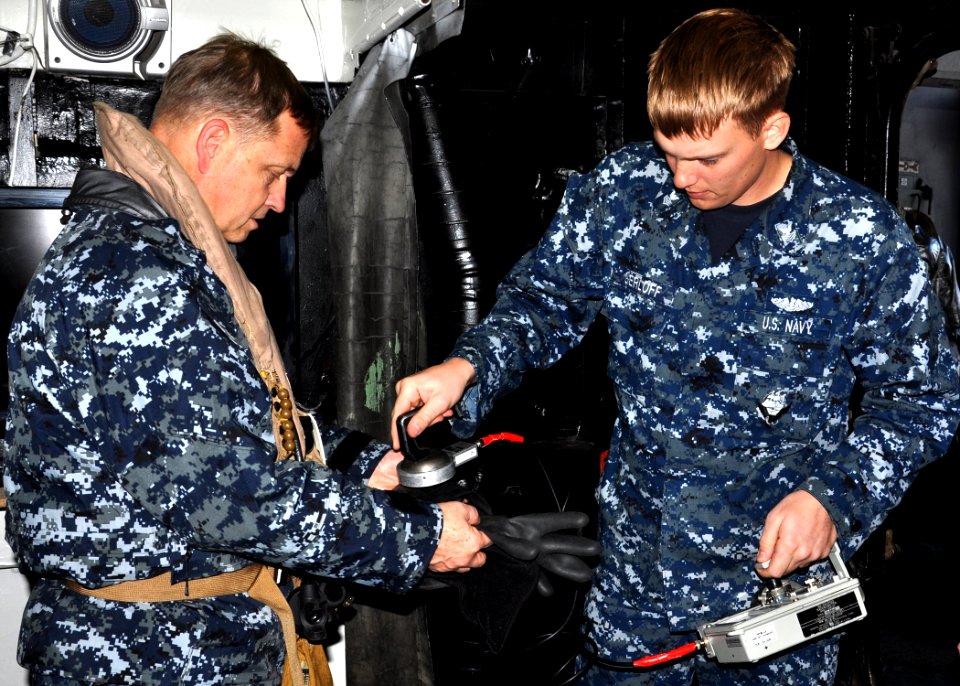 US Navy 110329-N-OM503-037 Machinist's Mate 1st Class Nicholas Gerloff uses a Radiac meter on Rear Adm. Jeffery