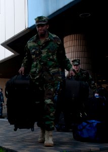US Navy 110328-N-EA192-001 Navy Diver 1st Class Clessie Simmons, assigned to Ships Repair Facility at Fleet Activities Yokosuka, loads luggage onto