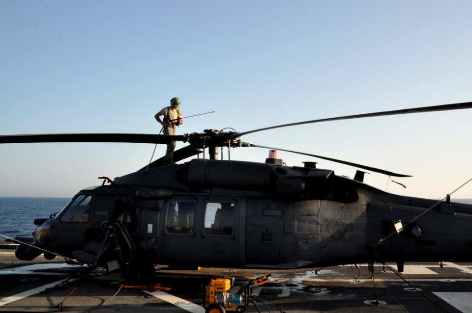 US Navy 110327-N-7293M-188 Staff Sgt. Garrett Fillingham prepares to wash down the main rotors on an HH-60G Pave Hawk helicopter aboard the amphibi