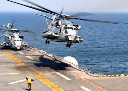 US Navy 110329-N-5538K-240 A CH-53E Sea Stallion helicopter takes off from the forward-deployed amphibious assault ship USS Essex (LHD 2)