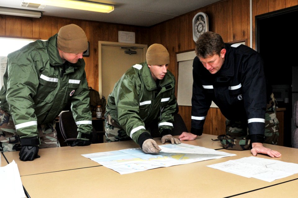 US Navy 110325-N-MU720-006 Builder 2nd Class Joshua Knolla, left, from Wichita Kan., and Construction Mechanic 1st Class Timothy Plummer, center, g