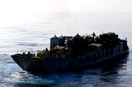 US Navy 110329-N-RC734-010 Landing Craft Utility (LCU) 1648 departs the well deck aboard USS Comstock (LSD 45) photo