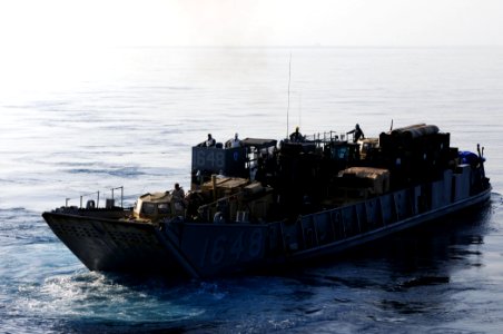 US Navy 110329-N-RC734-010 Landing Craft Utility (LCU) 1648 departs the well deck aboard USS Comstock (LSD 45)