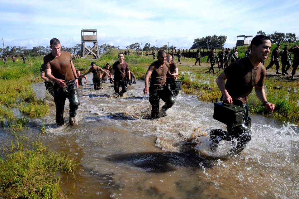 US Navy 110325-N-SI773-954 Sailors carry ammo cans through a four-pit run obstacle during the 2nd annual Vietnam-6 Memorial Super Squad competition