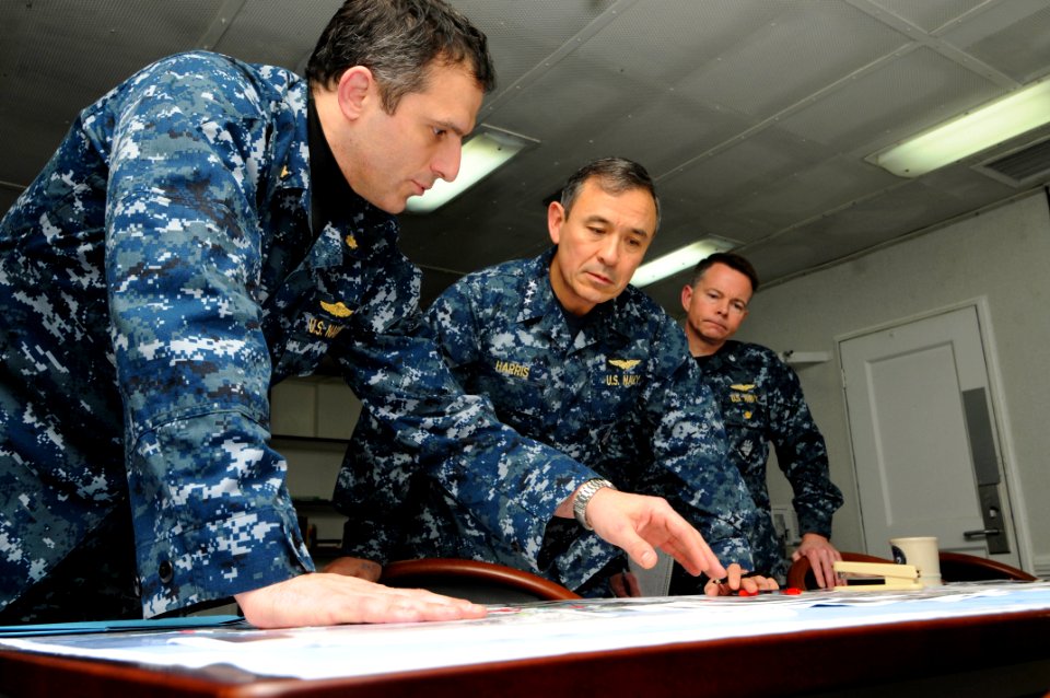 US Navy 110324-N-IZ292-005 Vice Adm. Harry B. Harris Jr., commander of the Joint Force Maritime Component, receives an overnight situation report