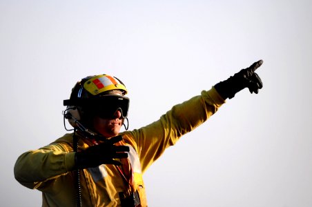 US Navy 110326-N-6505H-242 Aviation Boatswain's Mate (Handling) 2nd Class Isaac Paddock directs an aircraft aboard USS Carl Vinson (CVN 70)