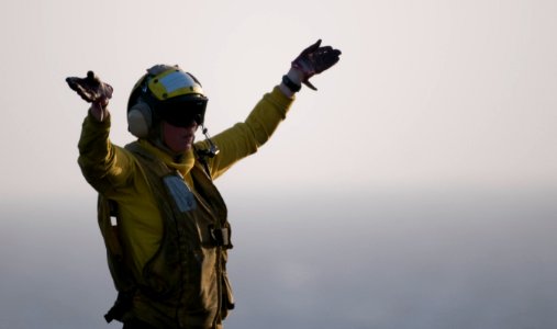 US Navy 110326-N-6505H-352 Aviation Boatswain's Mate (Handling) 3rd Class Alexsis LaBrake directs an aircraft aboard USS Carl Vinson (CVN 70)