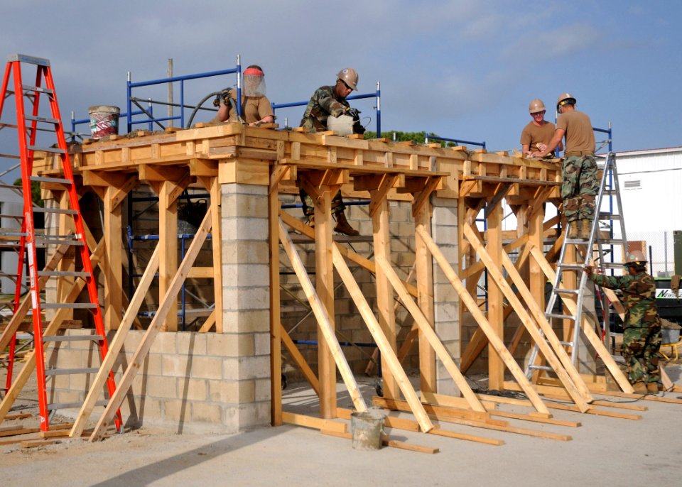 US Navy 110324-N-AW868-040 Seabees complete an overhead concrete pour at a bus stop project at Camp Mitchell