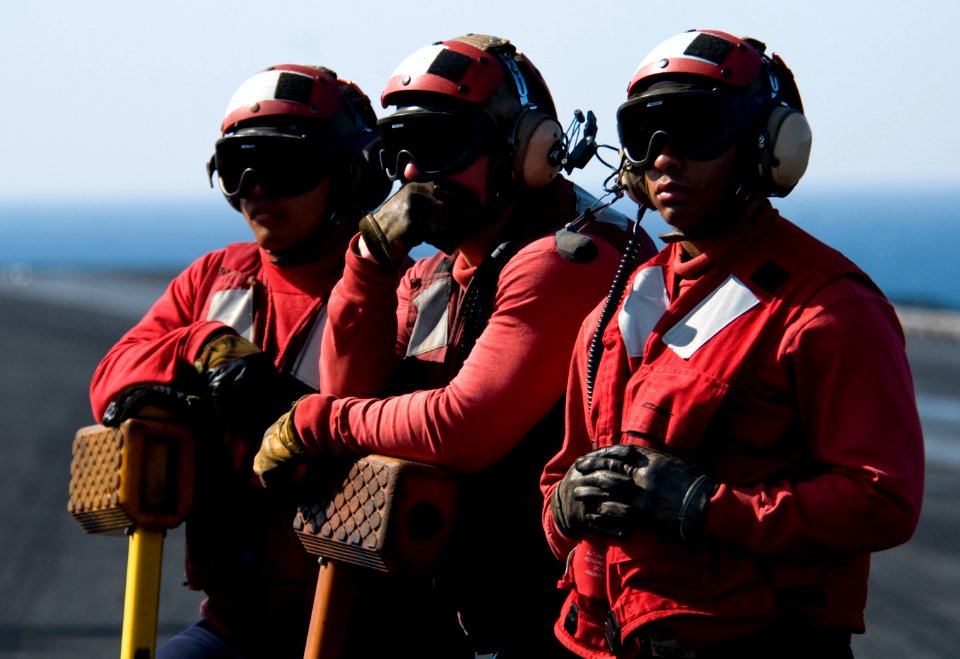 US Navy 110330-N-6320L-048 Sailors aboard the aircraft carrier USS Carl Vinson (CVN 70) wait to chock and chain an aircraft
