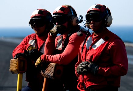 US Navy 110330-N-6320L-048 Sailors aboard the aircraft carrier USS Carl Vinson (CVN 70) wait to chock and chain an aircraft