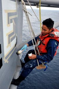 US Navy 110327-N-4031K-091 Quartermaster 3rd Class Albert Francisco paints an