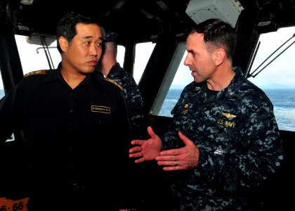 US Navy 110327-N-5538K-104 Capt. David Fluker, commanding officer of the forward-deployed amphibious assault ship USS Essex (LHD 2), discusses ship