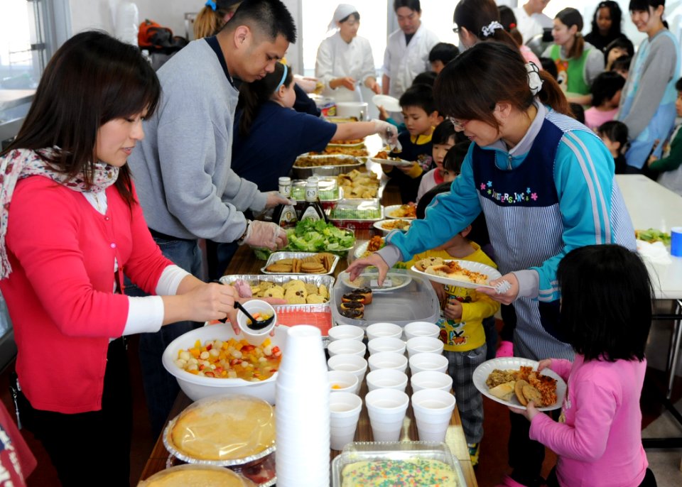 US Navy 110327-N-MU720-043 Volunteers from Naval Air Facility Misawa and Misawa Air Base serve a home cooked meal to children and staff members at