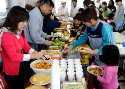 US Navy 110327-N-MU720-043 Volunteers from Naval Air Facility Misawa and Misawa Air Base serve a home cooked meal to children and staff members at