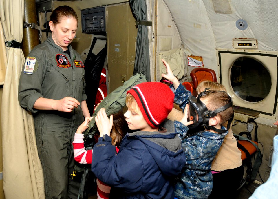 US Navy 110330-N-ZK021-009 Naval Air Crewman 2nd Class Jennifer Brawning explains functions of in-flight survival gear to children