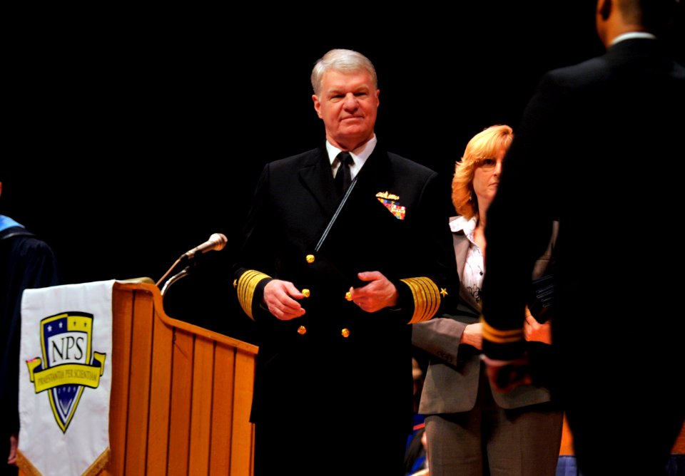 US Navy 110325-N-ZB612-100 Chief of Naval Operations (CNO) Adm. Gary Roughead presents diplomas to students during a graduation ceremony at the Nav