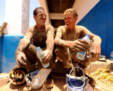 US Navy 110331-N-SN160-035 Steelworker 3rd Class Caleb Baker and Equipment Operator Constructionman Eric Hofmans take a hydration break during the photo