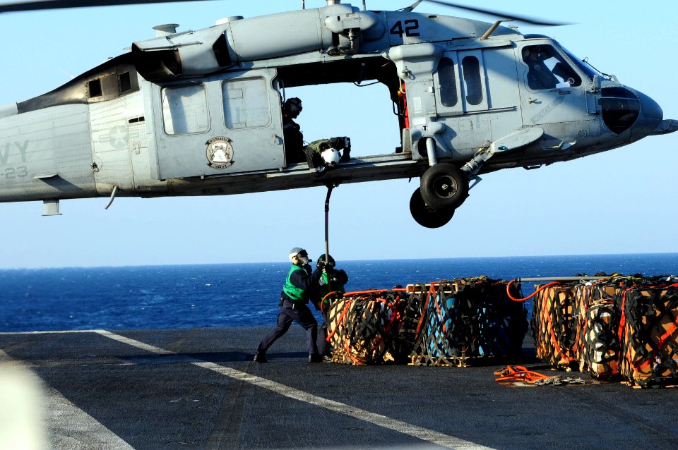 US Navy 110328-N-SG869-036 Sailors assigned to the supply department of the aircraft carrier USS Ronald Reagan (CVN 76) hook a pallet of supplies t