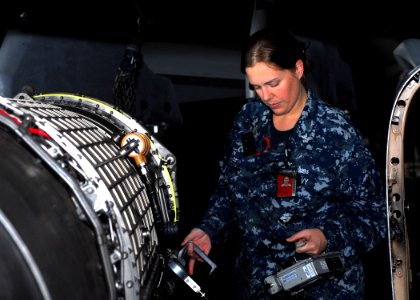 US Navy 110401-N-GL340-041 Machinist's Mate 1st Class Margaret Huff checks a jet engine for radiation