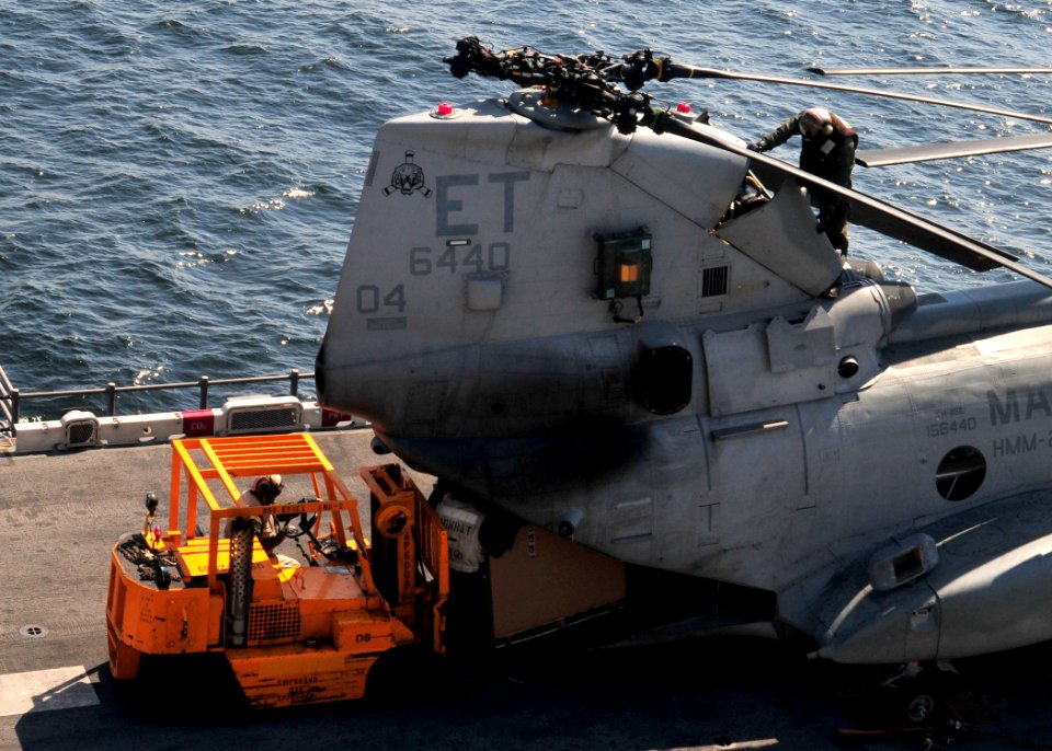 US Navy 110329-N-5538K-180 Marines load humanitarian assistance supplies into a CH-46E Sea Knight helicopter on the flight deck of the forward-depl