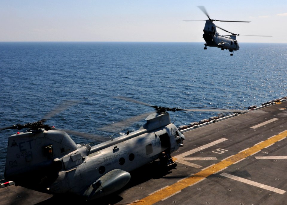 US Navy 110329-N-5538K-220 A CH-46E Sea Knight helicopter carrying humanitarian assistance supplies takes off from the forward-deployed amphibious