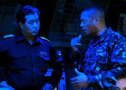 US Navy 110327-N-5538K-054 Capt. Bradley Lee, commander of Amphibious Squadron (PHIBRON) 11, discusses operational capabilities with Japan Maritime