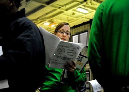 US Navy 110327-N-9626Y-020 viation Boatswain's Mate (Equipment) Carlee Udischas stands in line during a warfare day to get signatures for her perso